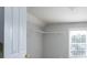 Bright walk-in closet with a window, custom shelving and neutral walls at 4392 Sunset Rose Dr, Fort Mill, SC 29708