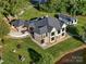 Aerial view of a house with a large, well-manicured lawn, surrounded by lush greenery and mature trees at 445 Sundown Rd, Mooresville, NC 28117