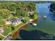 Expansive aerial view of waterfront home, showcasing lush landscaping and private dock at 445 Sundown Rd, Mooresville, NC 28117