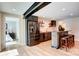 A modern bar area with stainless steel refrigerator, wooden shelves, and seating at 445 Sundown Rd, Mooresville, NC 28117