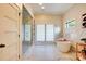 A spacious bathroom featuring a glass enclosed shower, soaking tub, marble floors, and lots of natural light at 445 Sundown Rd, Mooresville, NC 28117
