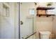 Tiled walk-in shower and wooden shelves add to this bathroom's charm at 445 Sundown Rd, Mooresville, NC 28117