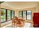 Bright dining room with large windows offering lake views and a vintage Coca-Cola refrigerator at 445 Sundown Rd, Mooresville, NC 28117