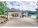 Lakefront home with a large driveway, covered parking, and stylish architecture at 445 Sundown Rd, Mooresville, NC 28117