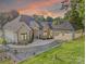 Beautiful brick home featuring a covered carport, lush landscaping, and a charming walkway at 445 Sundown Rd, Mooresville, NC 28117