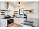 Modern kitchen featuring white subway tile, granite countertops, and stainless steel appliances at 445 Sundown Rd, Mooresville, NC 28117