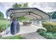 Outdoor dining area under a covered patio with ceiling fans and lake views, great for entertaining at 445 Sundown Rd, Mooresville, NC 28117