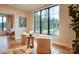 Cozy sitting area with hardwood floors, neutral armchairs, and a large window overlooking the lake at 445 Sundown Rd, Mooresville, NC 28117