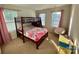 Bright bedroom featuring a wooden bunk bed, plush carpeting, and two windows with natural light at 5005 Blue Serenity Ct, Denver, NC 28037