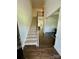 Inviting entryway featuring hardwood floors, a staircase, and views into the formal dining room at 5005 Blue Serenity Ct, Denver, NC 28037