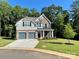 Charming two-story home with a two-car garage, stone accents, and a well-manicured lawn at 5005 Blue Serenity Ct, Denver, NC 28037