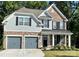 Charming two-story home with a stone and shingle facade, dark shutters, and a welcoming front porch at 5005 Blue Serenity Ct, Denver, NC 28037