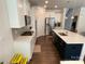 Modern kitchen featuring stainless steel appliances, an island, and white cabinets for a sleek look at 5005 Blue Serenity Ct, Denver, NC 28037