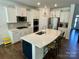Modern kitchen with stainless steel appliances, white cabinets, large island with bar stool seating at 5005 Blue Serenity Ct, Denver, NC 28037