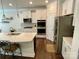 Modern kitchen with stainless steel appliances, white cabinets, and a large island at 5005 Blue Serenity Ct, Denver, NC 28037