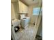 Well-lit laundry room featuring a sink, washer, dryer, and storage cabinets at 5005 Blue Serenity Ct, Denver, NC 28037