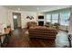 Open living room with a fireplace, hardwood floors, and large windows offering ample natural light at 5005 Blue Serenity Ct, Denver, NC 28037