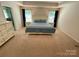 Spacious main bedroom with neutral carpet, white furniture, and two windows for ample lighting at 5005 Blue Serenity Ct, Denver, NC 28037