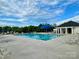 Community pool featuring lounge chairs, a pool house, and a clear blue swimming pool at 5005 Blue Serenity Ct, Denver, NC 28037