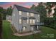 Beautiful back exterior with large windows, deck, patio, and landscaped yard, perfect for outdoor living at 5021 Meadow Woods Dr, Lowell, NC 28098