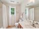 Bright bathroom with a white vanity, large mirror, tub and beautiful natural light at 5021 Meadow Woods Dr, Lowell, NC 28098