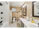 Bathroom featuring double sinks, large mirrors, and a shower/tub combo at 5021 Meadow Woods Dr, Lowell, NC 28098