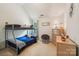 Cozy bedroom featuring a bunk bed, vaulted ceiling, and warm natural light at 5021 Meadow Woods Dr, Lowell, NC 28098