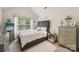 Stylish bedroom featuring a tufted headboard, ample natural light, and neutral tones at 5021 Meadow Woods Dr, Lowell, NC 28098