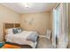 Cozy bedroom featuring a comfortable bed, carpeted floors, and soothing natural light from the window at 5021 Meadow Woods Dr, Lowell, NC 28098