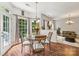 Cozy breakfast nook with a glass-topped table, wood floors, and views of the backyard at 5021 Meadow Woods Dr, Lowell, NC 28098