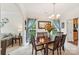 Bright dining room featuring a wooden table, chandelier, and large windows with blue curtains at 5021 Meadow Woods Dr, Lowell, NC 28098