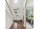 Bright and open foyer featuring hardwood floors, staircase, and ample natural light at 5021 Meadow Woods Dr, Lowell, NC 28098