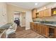 Classic kitchen with wood cabinets, stone countertops, breakfast bar and an open view into the living area at 5021 Meadow Woods Dr, Lowell, NC 28098
