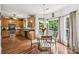 Charming kitchen with wood cabinets, stainless steel appliances, and adjacent breakfast nook with backyard views at 5021 Meadow Woods Dr, Lowell, NC 28098