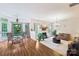 Spacious living room with hardwood floors and adjacent dining area providing an open and connected living space at 5021 Meadow Woods Dr, Lowell, NC 28098