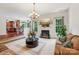 Open-concept living room featuring a fireplace, large windows, and a view of the adjacent kitchen area at 5021 Meadow Woods Dr, Lowell, NC 28098