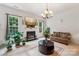Bright living room featuring a fireplace, large windows, and comfortable seating for a relaxing atmosphere at 5021 Meadow Woods Dr, Lowell, NC 28098