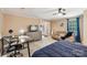 Large main bedroom with a ceiling fan, carpeted floors, desk, and access to a sitting area at 5021 Meadow Woods Dr, Lowell, NC 28098