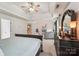 Bright main bedroom showcasing a large bed, dresser, and seating area with a ceiling fan at 5021 Meadow Woods Dr, Lowell, NC 28098