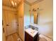 Well-lit bathroom featuring a decorative mirror, wood-look floors, and a tile backsplash at 5033 Baylor Dr, Charlotte, NC 28210