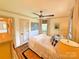 Cozy bedroom with a ceiling fan, natural light, and neutral color palette at 5033 Baylor Dr, Charlotte, NC 28210