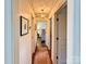 Hallway featuring hardwood floors, neutral walls, and trim at 5033 Baylor Dr, Charlotte, NC 28210