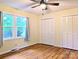 Bedroom featuring hardwood floors, neutral walls, ceiling fan, windows providing plenty of natural light and outdoor views at 5628 White Store Rd, Wingate, NC 28174