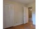 Bedroom featuring hardwood floors, neutral walls, and closet space with an en-suite at 5628 White Store Rd, Wingate, NC 28174