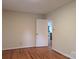 Bedroom featuring hardwood floors, neutral walls, and view of other rooms in the house at 5628 White Store Rd, Wingate, NC 28174