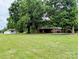 Spacious front yard with a brick home and a detached outbuilding at 5628 White Store Rd, Wingate, NC 28174