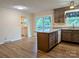 Modern kitchen and dining area with dark wood cabinets and floors, an island, and a sliding door at 5628 White Store Rd, Wingate, NC 28174