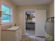 Laundry room with a utility sink, and a doorway into the kitchen at 5628 White Store Rd, Wingate, NC 28174
