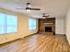 Spacious living room with wood floors, brick fireplace, and natural light at 5628 White Store Rd, Wingate, NC 28174