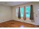 Cozy living room with hardwood floors and ample natural light through large windows, creating a welcoming atmosphere at 5628 White Store Rd, Wingate, NC 28174